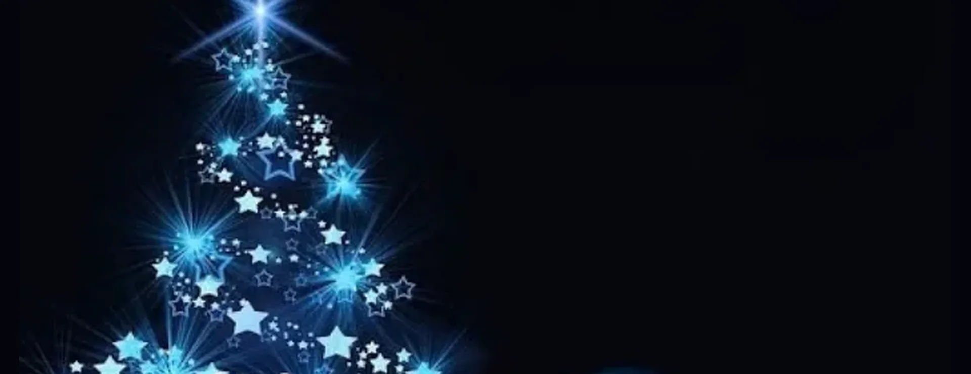A Christmas tree drawn in glowing blue stars on a dark night sky